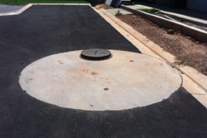 imageshows a loose cover sitting too high after the bitumen was laid 